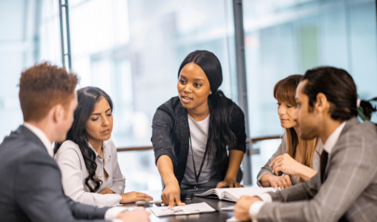 Millennial leader explaining something to a work team